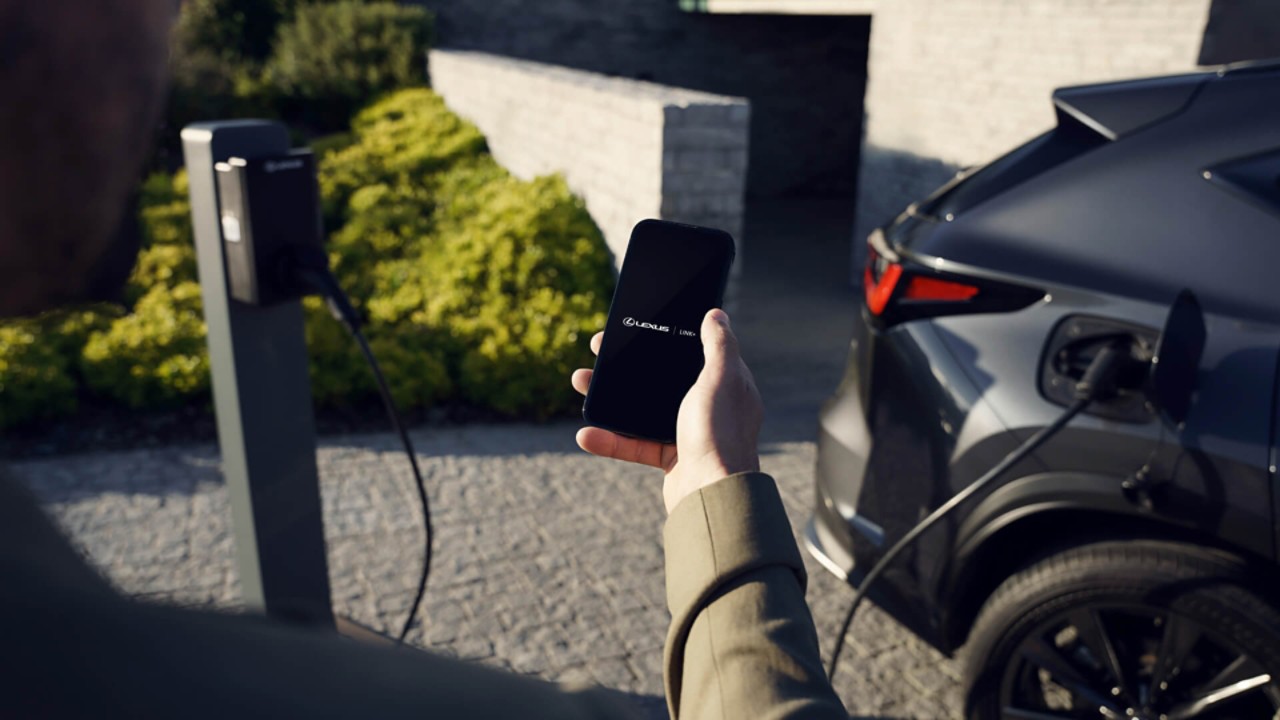 A person using a mobile phone to access the Lexus Link+ app